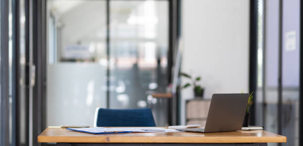 istock Office desk with documents and laptop on table in office. 1522473298