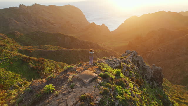 Woman watching sunset over the volcanic landscape in Masca valley, Tenerife