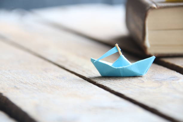 istock Paper boat on table. Summer travel concept. 1522518899