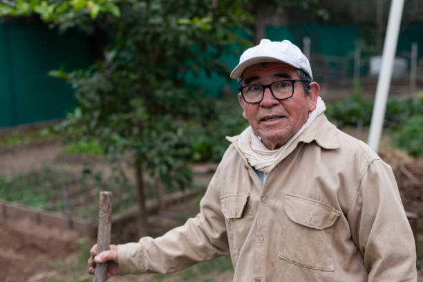 istock man in his 70's holding a shovel in an orchard 1522538176