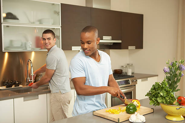 Gay couple preparing a healthy meal stock photo