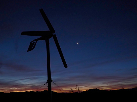 Wind turbine against a pre-dawn sky