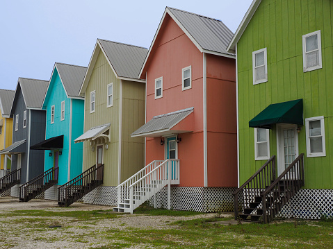 Row of narrow, colorful beach houses