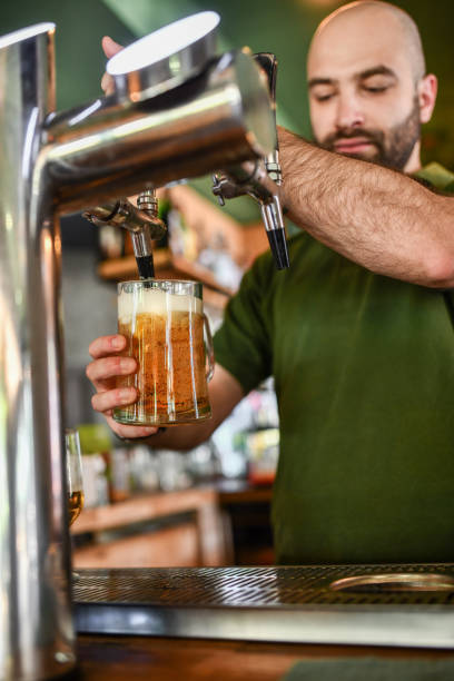 istock Full Beer Pint Filled On Tap By Bearded Bartender 1522564472