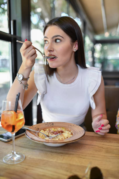 istock Beautiful Female Eating Omelet In Restaurant 1522566592