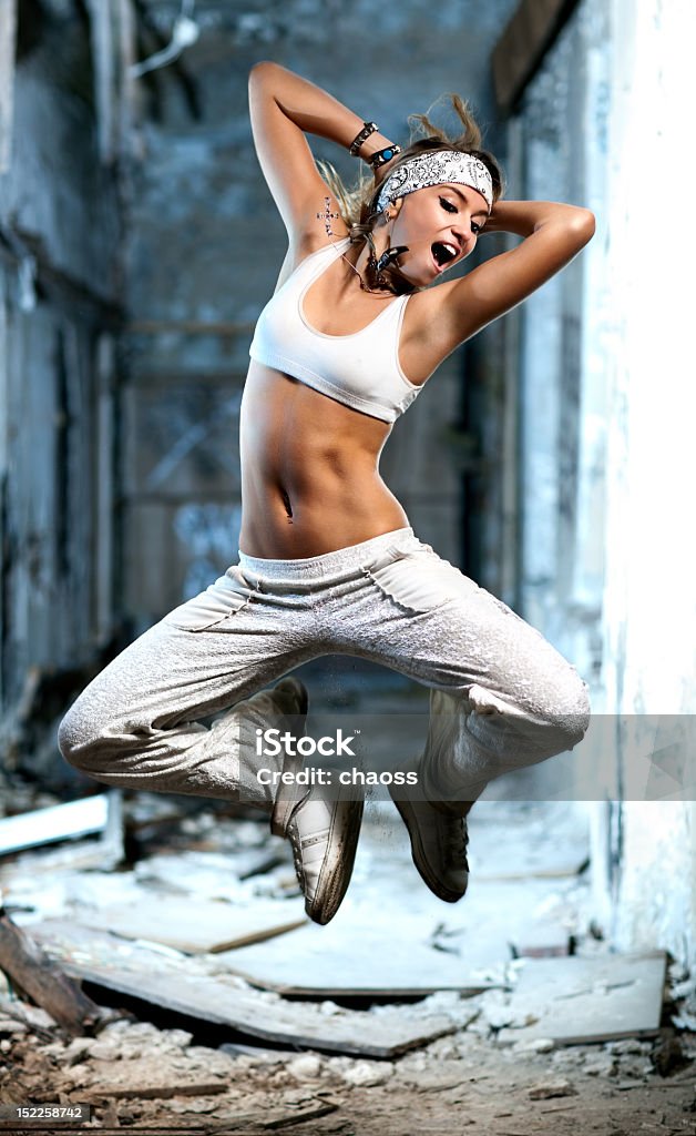 Young woman jumping Young woman jumping on industrial background. 20-29 Years Stock Photo