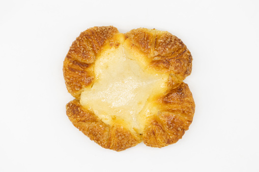 An overhead view of a simple cheese Danish pastry on a white background