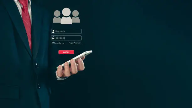 Photo of Login. A businessman's finger is holding a phone. Represents protection against external hacks. Concept of protection against code, viruses, firmware, and malware.