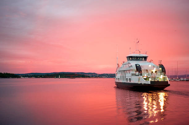 Cruise liner departuring from Oslo harbor Cruise liner floating away from the Olso harbor at dawn ferry stock pictures, royalty-free photos & images