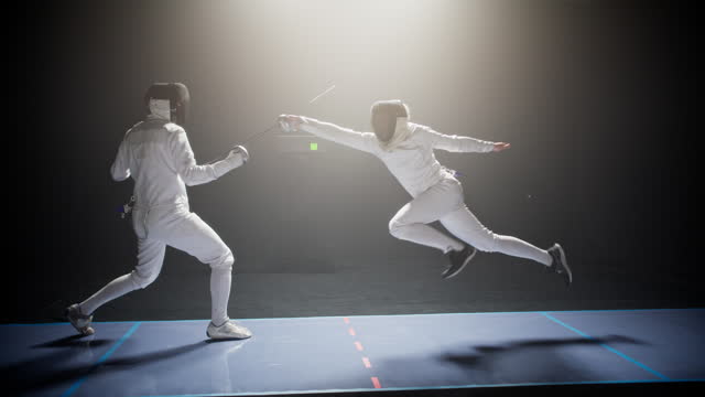 Two professional fencers clashing in combat. Jumping forward in offensive