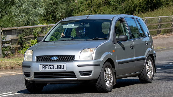 Milton Keynes,UK - July 7th 2023:   2003 silver FORD FUSION car travelling on a UK road