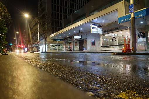 Auckland New Zealand - Julky 1 2023; Rainy night and wet grungy city street in darkness of morning before city come to life.