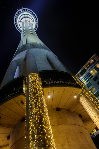 Auckland New Zealand - Julky 1 2023; Sky Tower illuminated and reaching into night sky