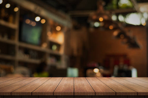 istock Empty wooden table top with lights bokeh on blur restaurant background. 1522696421