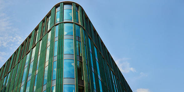 A modern city building with green cladding