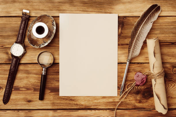 istock Old paper on brown wood background with feather 1522749093