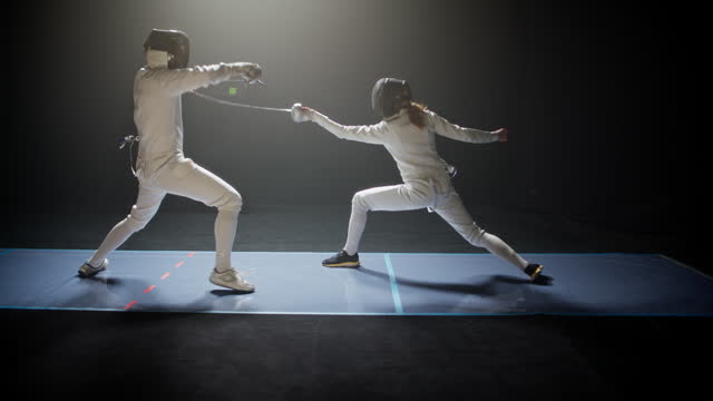 Two fencers bowing and clashing in combat. Attacking