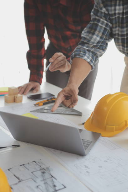istock Construction and structure concept of Engineer or architect meeting for project working with partner and engineering tools on model building and blueprint in working site, contract for both companies. 1522805198