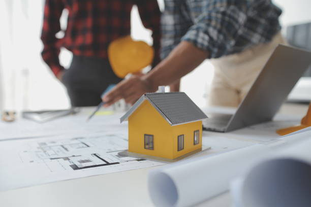 istock Construction and structure concept of Engineer or architect meeting for project working with partner and engineering tools on model building and blueprint in working site, contract for both companies. 1522805710