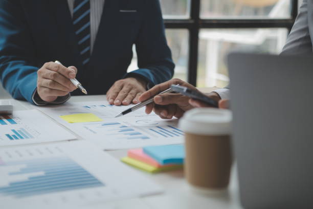 istock Financial analysts analyze business financial reports on a digital tablet planning investment project during a discussion at a meeting of corporate showing the results of their successful teamwork. 1522809330