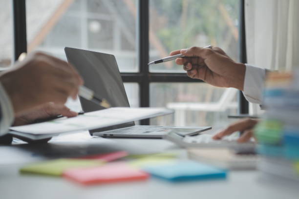 istock Financial analysts analyze business financial reports on a digital tablet planning investment project during a discussion at a meeting of corporate showing the results of their successful teamwork. 1522816108