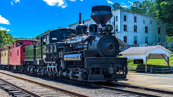 Cass, West Virginia, June 18, 2022 -  View of a Shay Steam Locomotive Warming Up to Pull a Group of Cabooses on a Sunny Summer Day