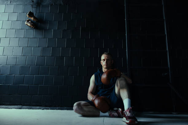 istock Tired boxer resting in gym after exercising. 1522873681