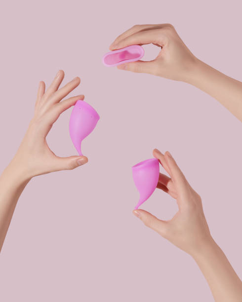 istock Female hands with reusable menstrual cups on pink background 1522875750