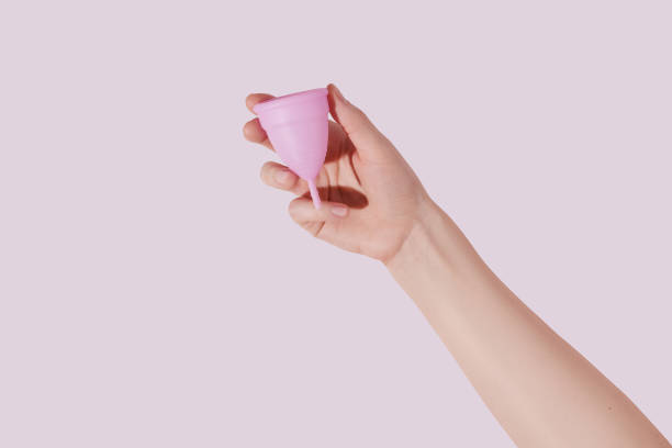 istock Female hand with menstrual cup on pink background 1522876261