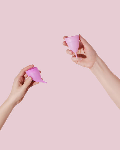 istock Female hands hold reusable menstrual cups on pink background 1522876262