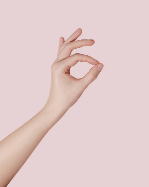 istock Female hand making ok sign on pink background. 1522876268