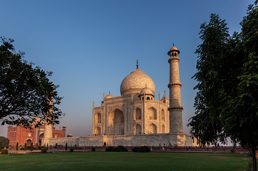Taj Mahal in morning light with the inscription of the coran in arabic letter meaning in english: This is an invitation to live on Earth as a good Muslim, Agra