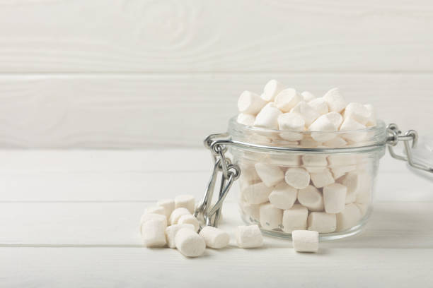istock Loose white marshmallows on white texture wood.Sweets and snacks for a snack.Chewy candy close-up.Copy space.Place for text. 1522892432