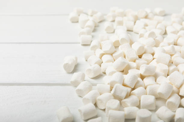 istock Loose white marshmallows on white texture wood.Sweets and snacks for a snack.Chewy candy close-up.Copy space.Place for text. 1522892440