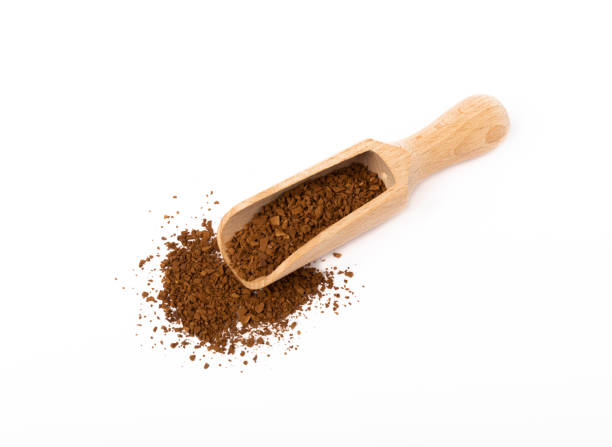 istock Soluble coffee grains in a wooden spoon isolated on a white background. 1522911196