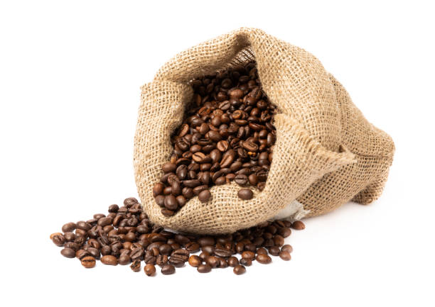 istock Coffee beans in a bag isolated on white background. 1522915336