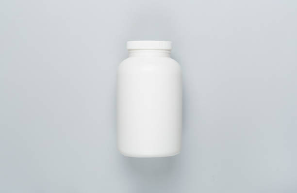 istock Plastic bottle with vitamins on color background, top view 1522922252
