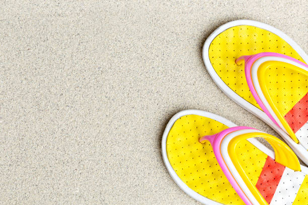 Rubber beach sandals yellow with red on the sand