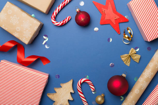 istock Gift boxes, paper's rools and decorations on color background, top view 1522949750