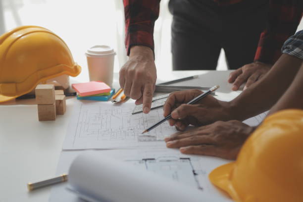 istock Construction and structure concept of Engineer or architect meeting for project working with partner and engineering tools on model building and blueprint in working site, contract for both companies. 1522963297