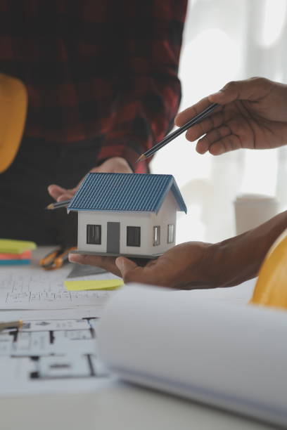 istock Construction and structure concept of Engineer or architect meeting for project working with partner and engineering tools on model building and blueprint in working site, contract for both companies. 1522964879