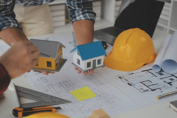 istock Construction and structure concept of Engineer or architect meeting for project working with partner and engineering tools on model building and blueprint in working site, contract for both companies. 1522964884