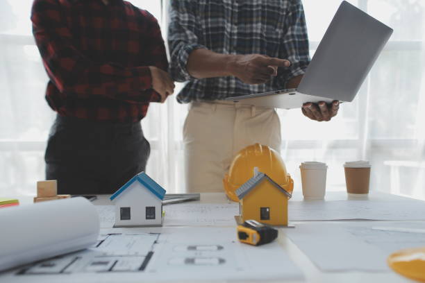 istock Construction and structure concept of Engineer or architect meeting for project working with partner and engineering tools on model building and blueprint in working site, contract for both companies. 1522966442