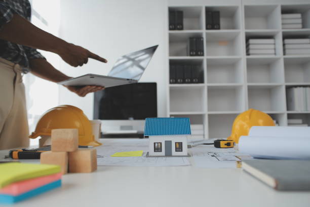 istock Construction and structure concept of Engineer or architect meeting for project working with partner and engineering tools on model building and blueprint in working site, contract for both companies. 1522966446