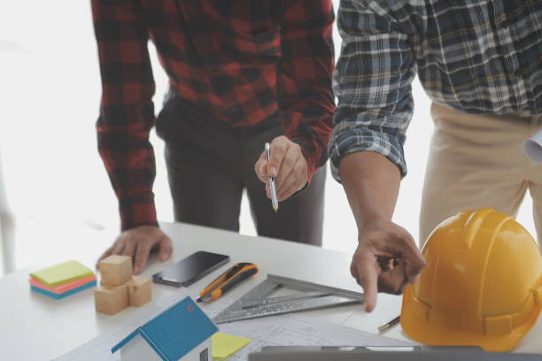 istock Construction and structure concept of Engineer or architect meeting for project working with partner and engineering tools on model building and blueprint in working site, contract for both companies. 1522966775