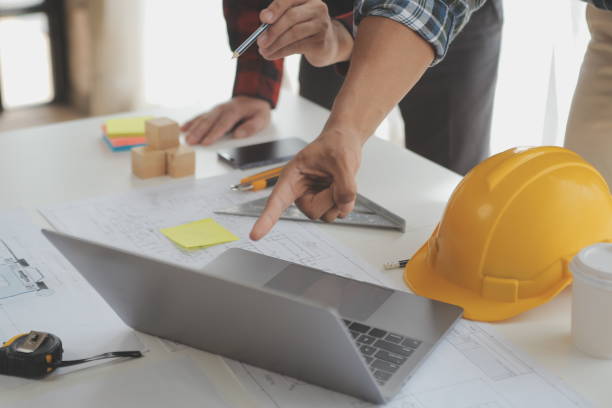 istock Construction and structure concept of Engineer or architect meeting for project working with partner and engineering tools on model building and blueprint in working site, contract for both companies. 1522966956