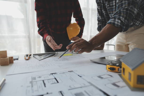 istock Construction and structure concept of Engineer or architect meeting for project working with partner and engineering tools on model building and blueprint in working site, contract for both companies. 1522967466
