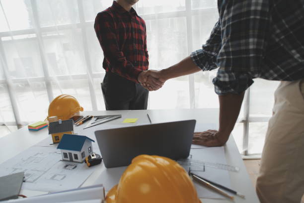 istock Happy workers at construction site, young civil engineer manager and architects handshaking at construction site and looking to next construction phase , cooperation teamwork concept. 1522968338