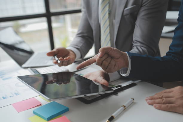 istock Financial analysts analyze business financial reports on a digital tablet planning investment project during a discussion at a meeting of corporate showing the results of their successful teamwork. 1522977140