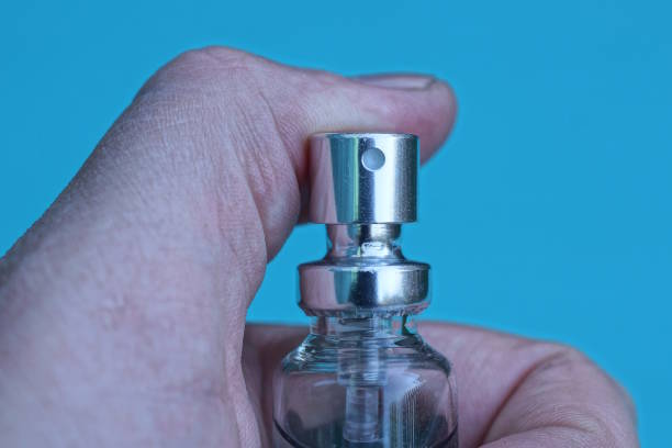 istock one gray bottle in fingers of hand 1523032514